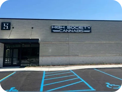 The High Society Cannabis sign over the store entrance, accessible parking in front