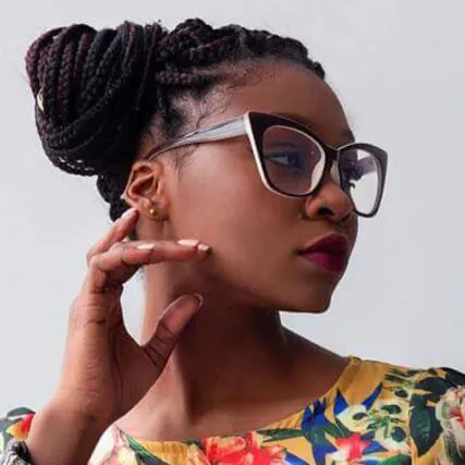 Stylish woman wearing oversized glasses and floral dress