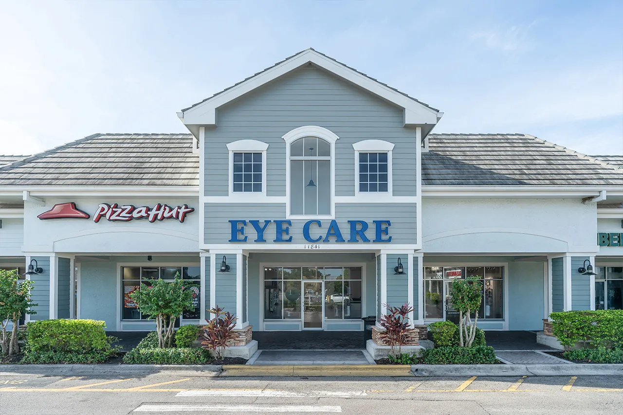 Exterior of eye care clinic with large blue signage and windows