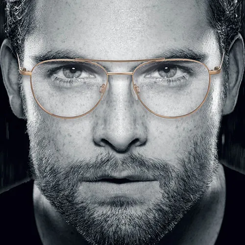Man in grayscale portrait wearing Charmant Titanium glasses