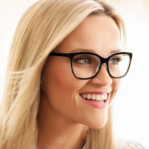 Blonde woman smiling in black Draper James eyeglasses
