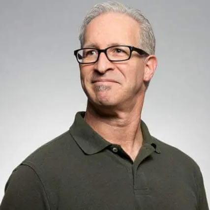 Older man with short gray hair wearing black eyeglasses