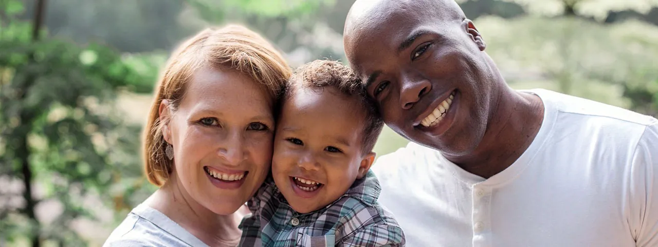 Mother Father and Son, multicultural family checking for eye disease.