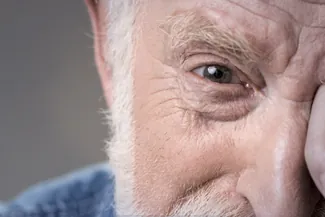 Close-up of senior man’s face showing detailed eye area