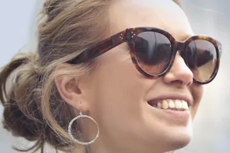 Smiling woman wearing oversized designer sunglasses